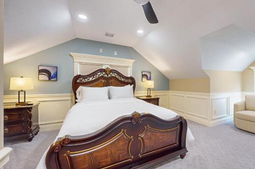 a bedroom with a large bed and a chair at Whole Home - Victory Residence in Holyoke
