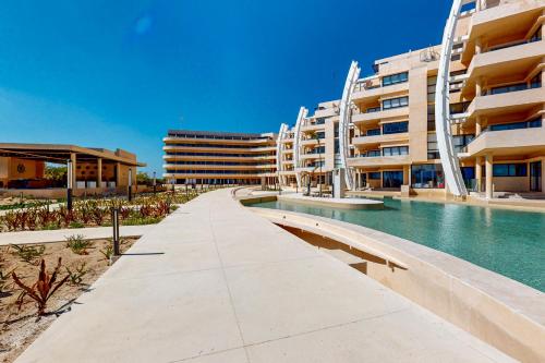 a swimming pool in front of a building at Seaside Serenity in Telchac Puerto