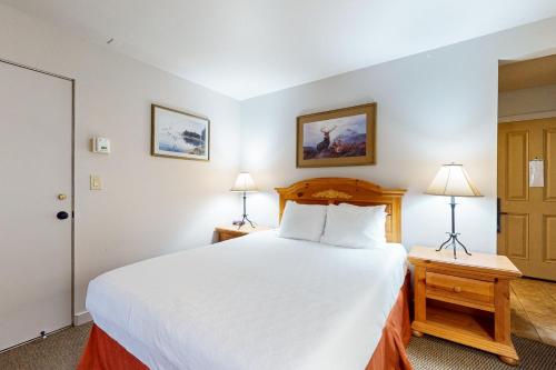 a bedroom with a large white bed and two lamps at Seventh Mountain Resort Unit 1914 in Bend
