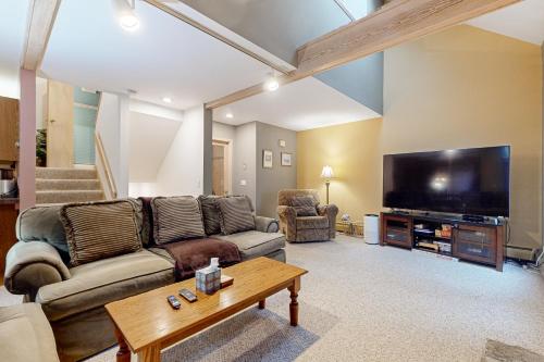 a living room with a couch and a flat screen tv at Haystack 9 in Wilmington