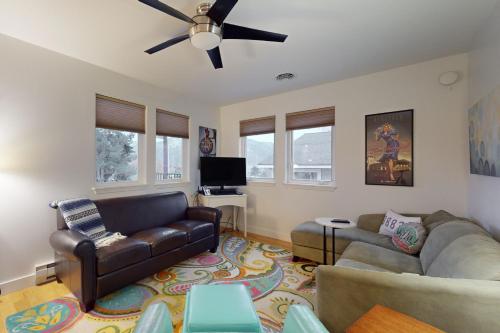 a living room with two couches and a ceiling fan at Manson Hideaway in Manson