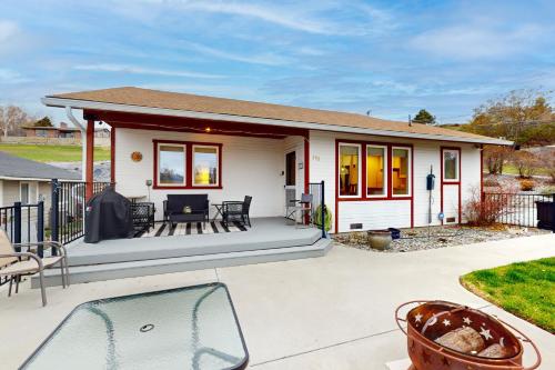 a small white house with a patio at Manson Hideaway in Manson
