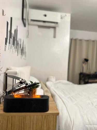 a room with a bed and a table with a candle at Affordable Condo in Cebu in Cebu City