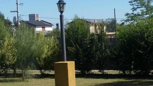 a light pole in a park with trees at Melodias Posada Boutique in Los Reartes