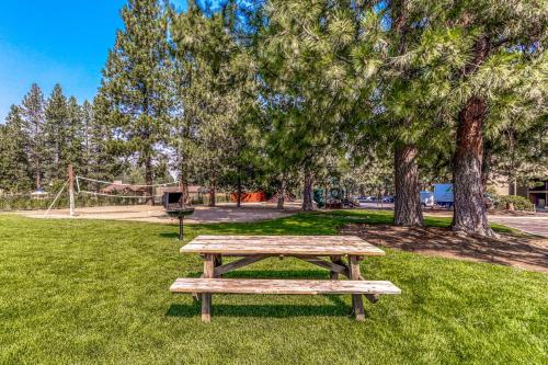 a wooden picnic table in a park with trees at Seventh Mountain Resort Unit 1913 in Bend