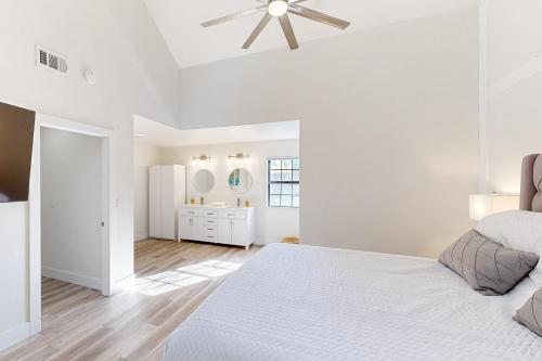 a white bedroom with a bed and a bathroom at Eagles Nest on Lake Arrowhead in Lake Arrowhead