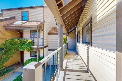 a walkway between two buildings with a porch at Eagles Nest on Lake Arrowhead in Lake Arrowhead