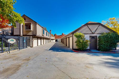 an empty street with a house and a fence at Eagles Nest on Lake Arrowhead in Lake Arrowhead