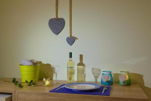 a table with a plate and wine glasses and hearts at Aptera Beach in Amoudara Herakliou