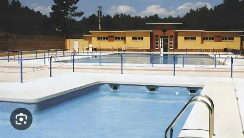 an empty swimming pool in front of a building at El Mirador De Campumedra in Vadillo