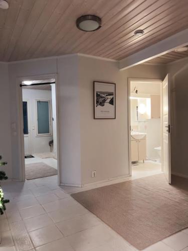 a living room with white walls and a ceiling at Winter Wonderland Home in Rovaniemi