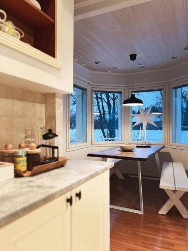a kitchen with a table and a dining room at Winter Wonderland Home in Rovaniemi