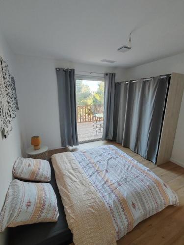 une chambre avec un grand lit et une fenêtre dans l'établissement Vue Panoramique au Mont st Clair, à Sète