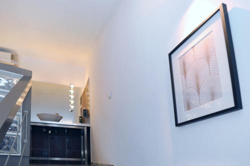 a picture hanging on a wall in a living room at Le Néliö in Aix-en-Provence