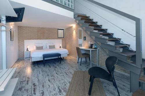 a hotel room with a bed and a staircase at Le Néliö in Aix-en-Provence