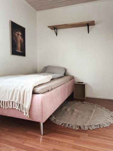 a bed in a room with a rug on the floor at Winter Wonderland Home in Rovaniemi