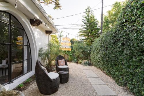 a pair of chairs sitting outside of a building at Casa Blanca Suite A1 - New, Private, Cozy! in Montecito