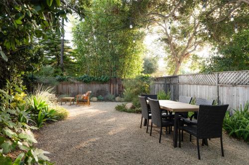 a patio with a table and chairs and a fence at Casa Blanca Suite A1 - New, Private, Cozy! in Montecito