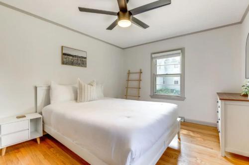 a white bedroom with a white bed and a ceiling fan at Owls Nest Cozy Westfield Home with Fire Pit in Westfield