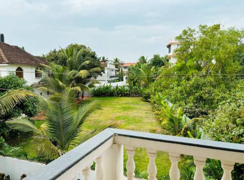 a balcony of a house with a yard at The Bodhi Tree Resort in Morjim