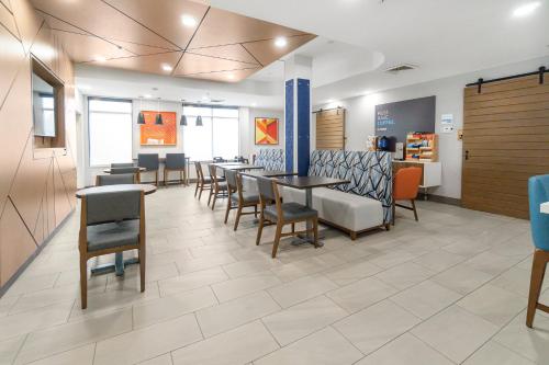 a waiting room with tables and chairs in a hospital at Holiday Inn Express Salt Lake City South - Midvale by IHG in Midvale