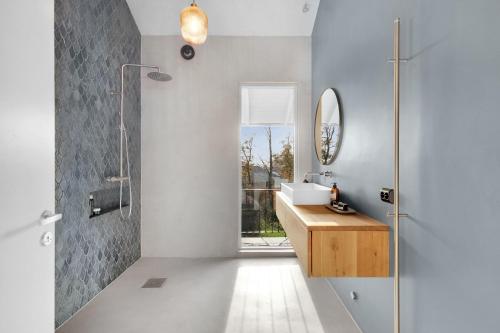 une salle de bain avec un lavabo et une douche avec un miroir dans l'établissement Fjord Nest By Stavanger BnB 29, à Stavanger