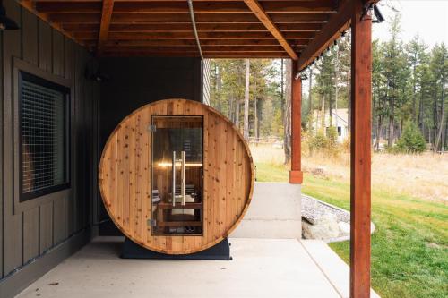 a building with a wooden circle on the side of it at Luxe Lakeside New Build by Flathead Lake Speakeasy in Somers