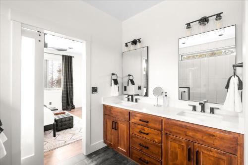 a bathroom with a sink and a mirror at Luxe Lakeside New Build by Flathead Lake Speakeasy in Somers