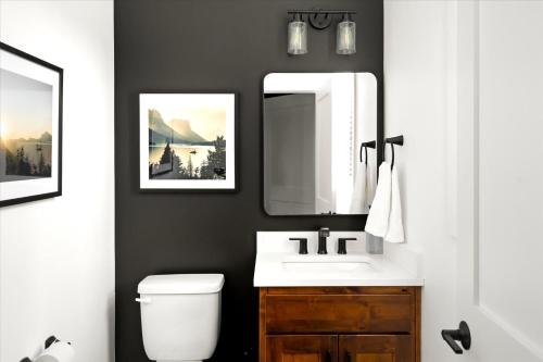 a bathroom with a sink and a mirror at Luxe Lakeside New Build by Flathead Lake Speakeasy in Somers