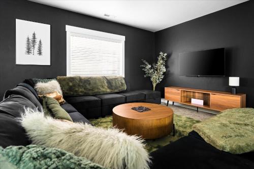 a living room with a couch and a table at Luxe Lakeside New Build by Flathead Lake Speakeasy in Somers