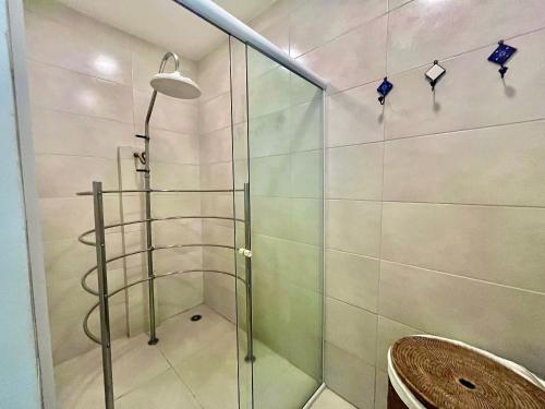 a shower with a glass door in a bathroom at LFlats Hotel Alameda Lorena Jardins in Sao Paulo