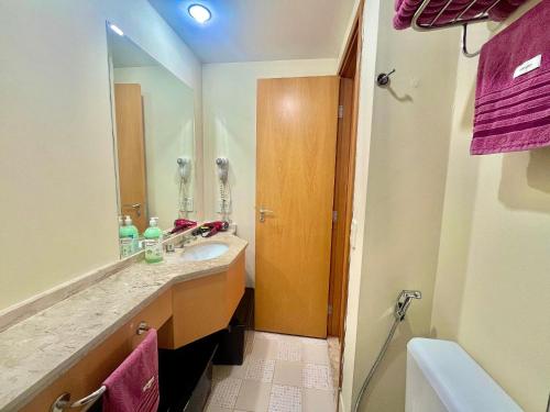 a bathroom with a sink and a mirror at LFlats Hotel Alameda Lorena Jardins in Sao Paulo