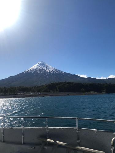 a view of a snow covered mountain from a boat at Parcela de Agrado "Entre Lagos y Volcanes" in Puyehue