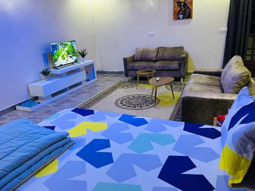a living room with a bed and a couch at RESIDENCE EL HADJI in Dakar