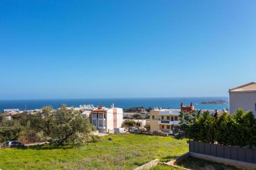 a view of the ocean from a house at Calma Holiday House in Atsipopoulo