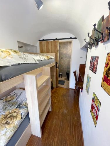 a room with two bunk beds and a hallway at Penzion BOHEM centrum in Český Krumlov