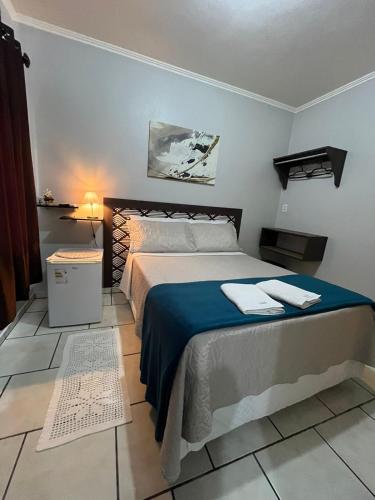 a bedroom with a large bed in a room at Familien Haus Pousada in Pomerode