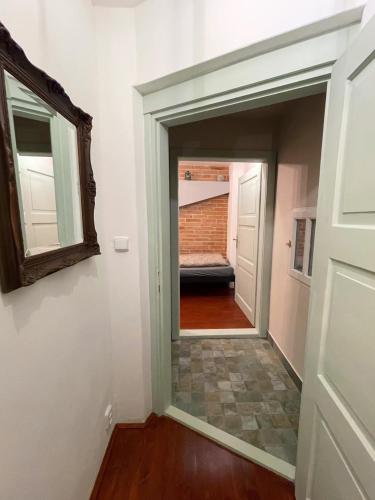a door leading into a hallway with a mirror at Penzion BOHEM centrum in Český Krumlov