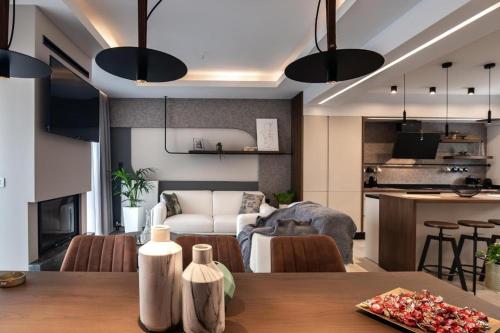 a living room and kitchen with a table and a couch at Calma Holiday House in Atsipopoulo