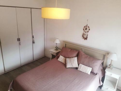 a bedroom with a bed with two pillows on it at Cuatro Estaciones in San Carlos de Bariloche