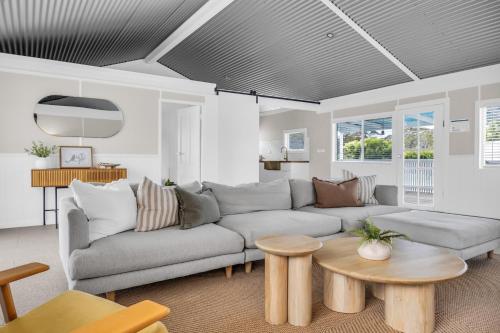 a living room with a couch and a table at Settlers Cottage and Settle Inn in Broadwater