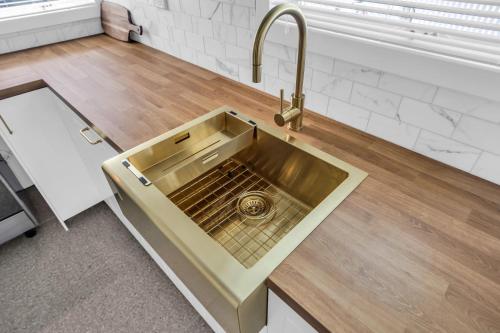 a kitchen sink with a faucet on a counter at Settlers Cottage and Settle Inn in Broadwater