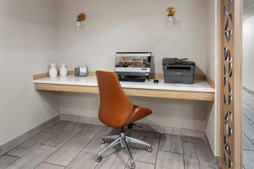an office with a desk with a computer and a chair at Candlewood Suites Harrisonburg by IHG in Harrisonburg