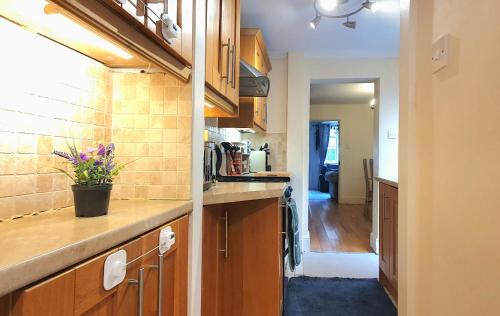 a kitchen with wooden cabinets and a counter top at Inviting 2-Bed Cottage in Windsor in Windsor