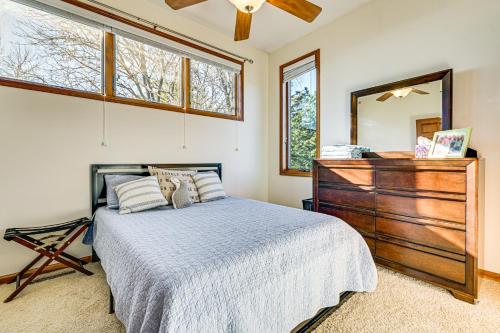 Un dormitorio con una cama, una cómoda y un espejo. en Waterfront Home with Boat Dock and Deck in Storm Lake!, en Storm Lake