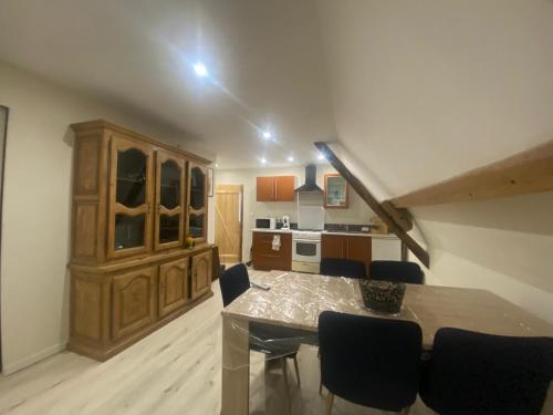 a kitchen and dining room with a table and chairs at Le petit refuge in Saint-Béron