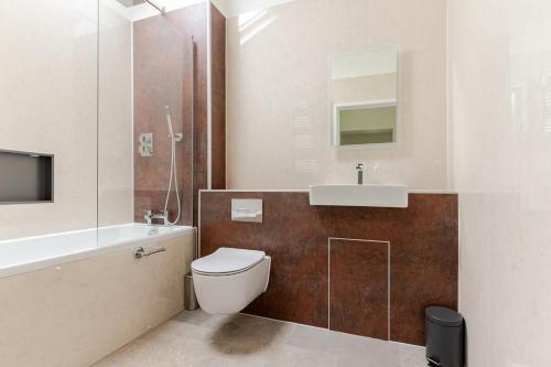 a bathroom with a toilet and a sink at The Old Coach House - Hot Tub - Dorset in Pimperne