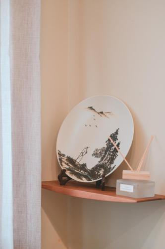 a plate on a shelf in a room at 苒得出門 - 台南包棟民宿 in Tainan