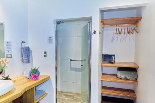 a bathroom with a shower and a sink at Takarua Lodge in Hanga Roa