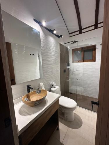 a bathroom with a sink and a toilet at Hotel Casa Sol de la Montaña villa de leyva in Villa de Leyva